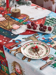 Detail of Christmas tablecloth with Santa and reindeer prints and woven texture