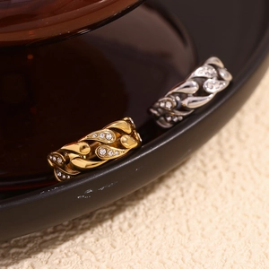 Macro shot of gold and silver plated link rings featuring pave-set cubic zirconia crystals