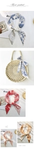 Detail view of retro twilly silk scarves with letter prints on a straw woven bag