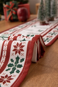 Close-up of snowflake and holly pattern on a festive cotton linen Christmas table runner