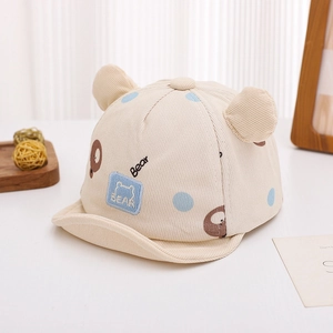 Detail of baby corduroy cap with bear ear decorations and dotted bear patterns