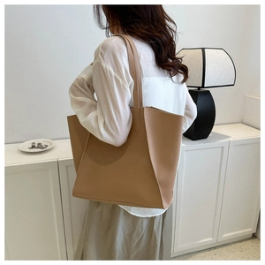 Model view showing the back profile of a large camel PU leather tote bag in a modern setting