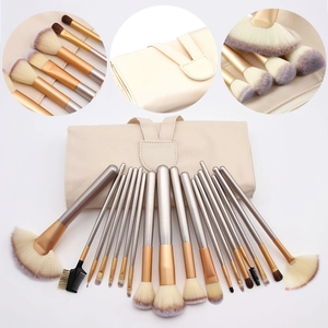 Macro shot of a 24-piece makeup brush set with wooden handles and beige roll-up case