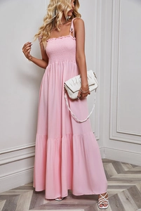 Detail of pink strapless maxi dress with shirred bodice and tiered flowy skirt design