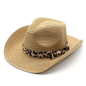 Detail view of woven straw cowboy hat with leopard print ribbon and bow decoration
