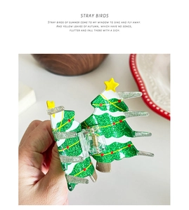 Detail of Christmas tree hair claw clip with green glitter and yellow star topper