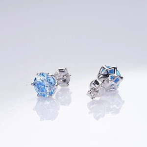 Macro shot of 1 carat blue moissanite earrings with silver classic six-prong setting