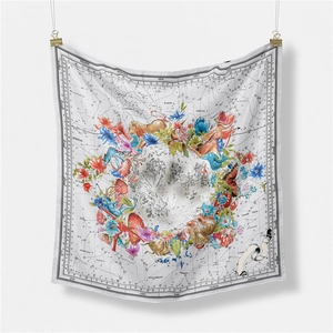 Macro shot of vintage astronomical silk scarf showing lunar patterns and floral details
