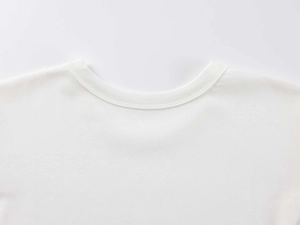 Close-up of the ribbed crew neck and double-needle stitching on a white modal sports T-shirt