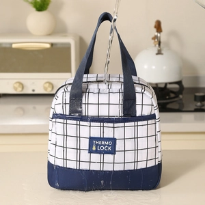 Waterproof insulated lunch bag with checkered pattern being rinsed under running water