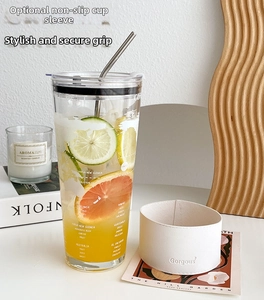 Detail of high-capacity glass cup with leather sleeve, stainless straw, and map print