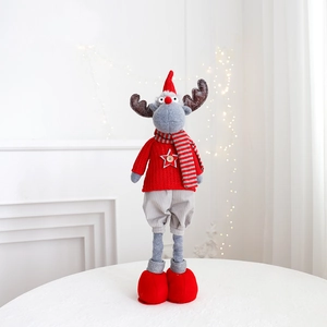 Close-up of a Christmas reindeer plush with red star button sweater and striped scarf