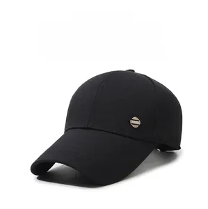 Detail view of black baseball cap side with metal Sport logo and twill cotton texture