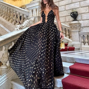 Detail of deep V-neckline with gold chain rings on a black sequin polka dot gown