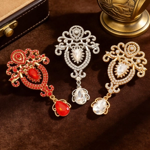 Macro shot of baroque style rhinestone brooches with teardrop crystal pendants