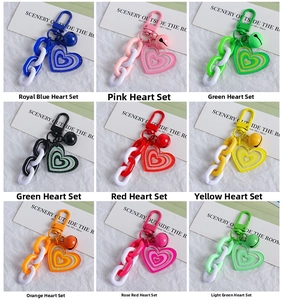 Detailed grid of colorful acrylic heart keychains with plastic chains and bells
