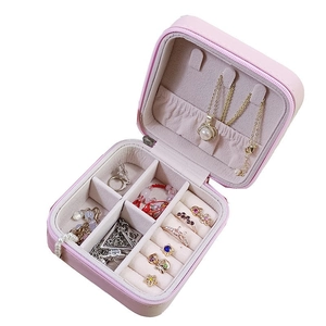 Pink faux leather portable jewelry organizer with zip closure and internal compartments