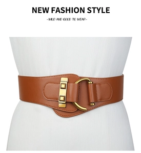 Detail of a brown leather wide belt featuring a vintage gold buckle and fine stitching