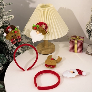 Christmas headband and clip set featuring Santa Claus and reindeer on a festive white table