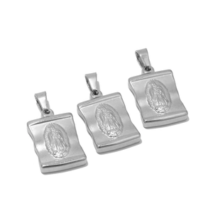 Detailed macro of three silver rectangular Virgin Mary relief cross pendants for jewelry