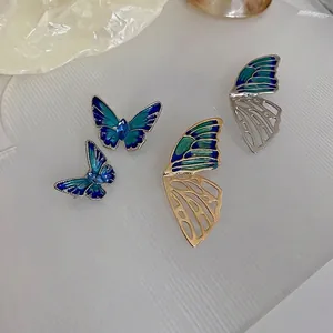 Elegant butterfly brooches with colorful gradient enamel and crystals on white background