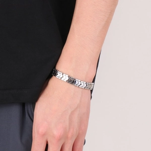 Close-up of polished silver V-shape link bone chain bracelet worn on male wrist