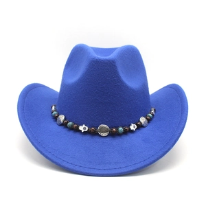 Close-up of blue felt cowboy hat with bohemian beaded band and silver charms