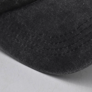 Macro view of washed cotton baseball cap brim with triple decorative stitching detail
