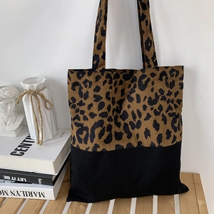 Detail of leopard print corduroy tote bag with black splicing and shoulder straps