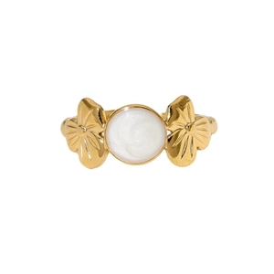 Golden stainless steel ring with white enamel disc and floral motifs on a white background