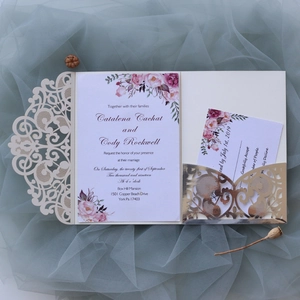 Detailed set of laser-cut wedding invitation with watercolor floral cards on blue tulle