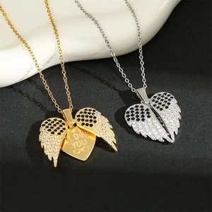 Detail of opening wing heart necklace with I Love You engraving and zircon stones