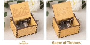 Detailed engraving of Godfather and Game of Thrones logos inside wooden music boxes
