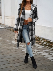 Macro detail of casual long hooded coat with black and white plaid pattern in street view