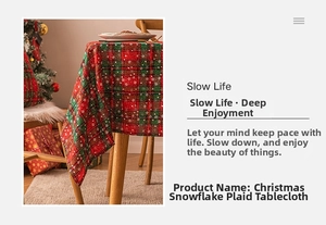 Detail of red and green plaid Christmas tablecloth with white snowflake print for dining