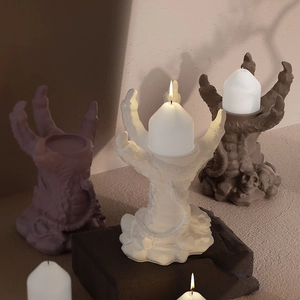Detailed view of gothic devil hand candle holder with skull relief and matte finish