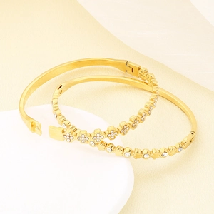 Elegant gold-plated cross clover bracelets with white zircon inlays on display