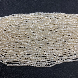 Macro view of multi-strand 2-3mm irregular white freshwater rice pearls for DIY jewelry making