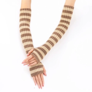 Close-up of striped beige and brown knitted arm warmers with elastic ribbed cuffs
