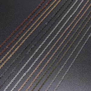 Macro view of assorted metal plated DIY cable chains in various colorful metallic finishes