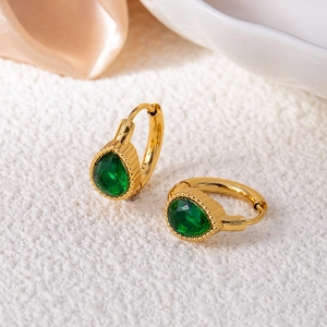 Detailed view of pear-cut emerald zircon earrings with gold beaded huggie hoops