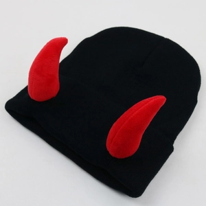 Detail showing the red plush horns and knitted texture of the black devil beanies