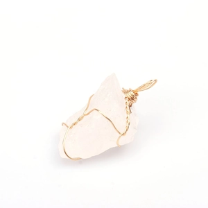 Detail of handmade gold wire-wrapped clear natural crystal raw stone pendant