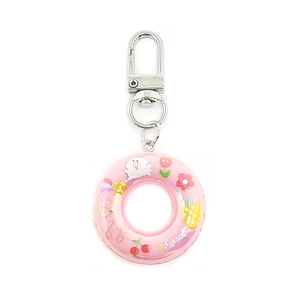 Macro detail of pink mini lifebuoy keychain with colorful cartoon fruit patterns