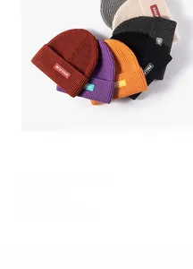 Close-up of knit beanies in various colors with New York embroidery details