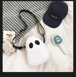 Flat lay of a cute white ghost PU crossbody bag with black adjustable nylon strap