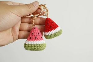 Close-up of handmade crochet watermelon slice keychains with detailed yarn texture