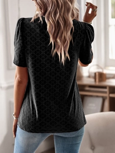 Detailed back view of a black short sleeve top featuring an elegant diamond textured pattern