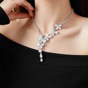 Detail of elegant silver flower necklace with clear zircon stones on a female model