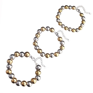 Close-up of three gold and silver mixed beaded stainless steel bracelets with lobster clasps